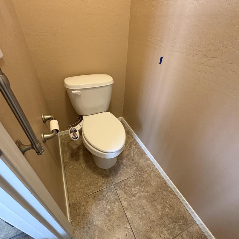 Toilet with installed client grab bar and angle stop