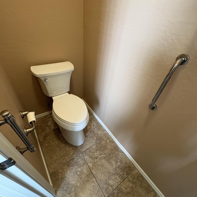 Toilet with installed client grab bar and angle stop