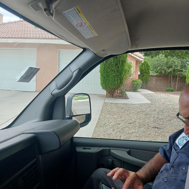 Vehicle interior with technician checking phone