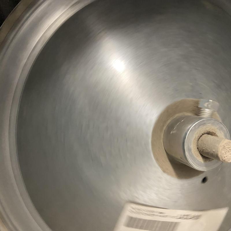 HVAC blower wheel and motor shaft close-up with dust buildup