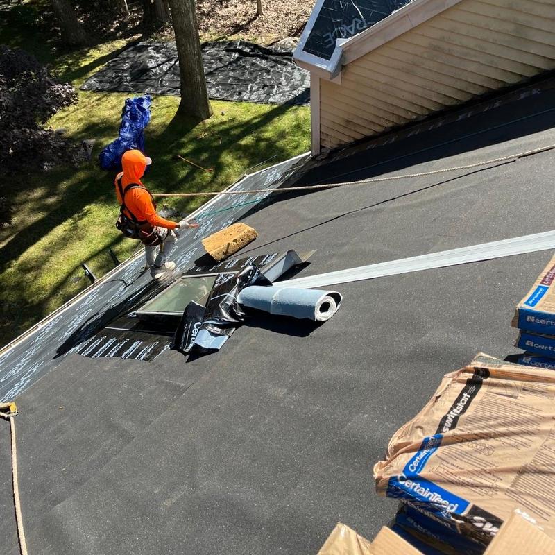 Roof underlayment installation with worker in Old Lyme