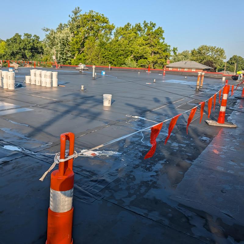 Commercial roof membrane with seam sealing in progress