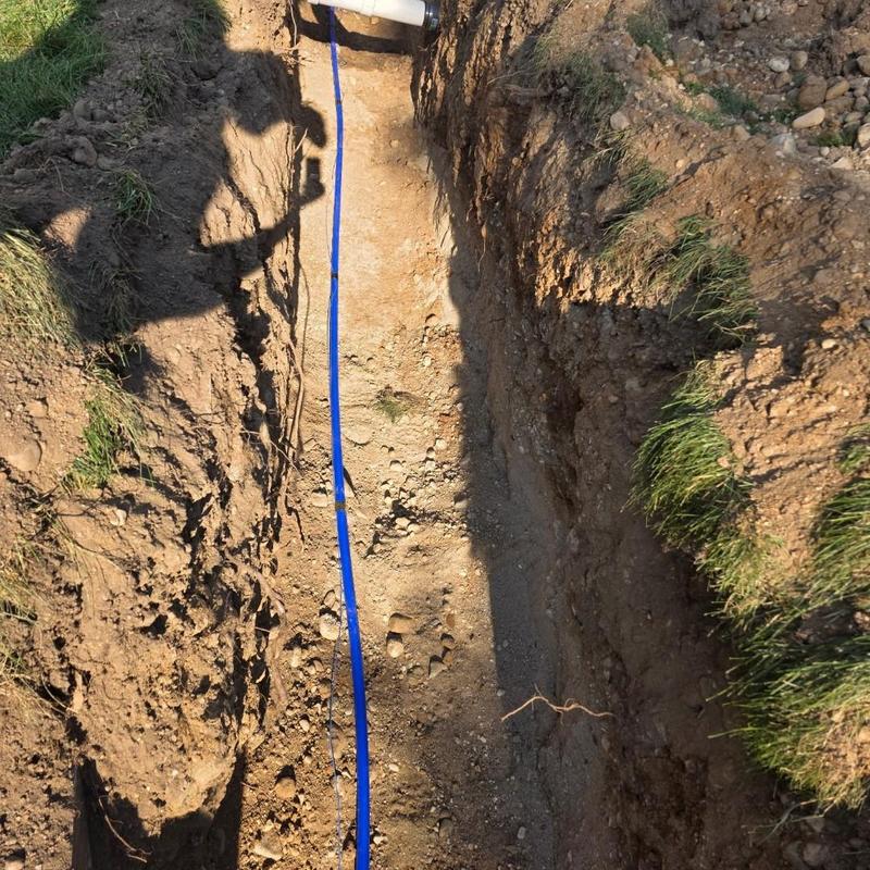 Blue water service line in deep trench installation