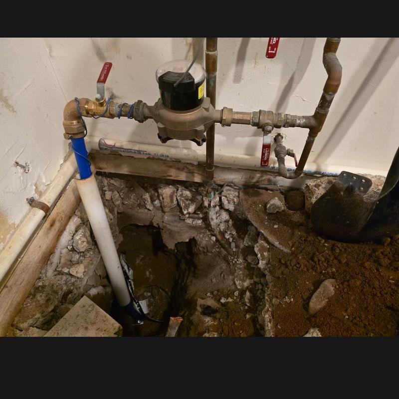 Water meter installation with pipe excavation inside home