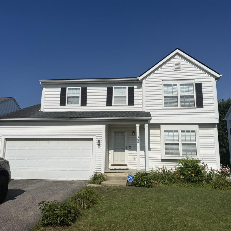 Roof shingles and siding inspection on two-story house
