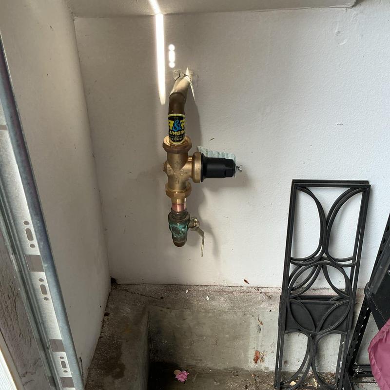 Water pressure regulator with shutoff valve on wall
