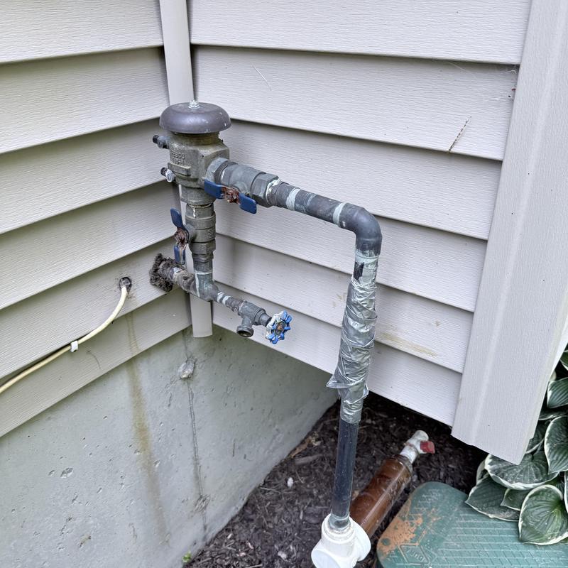 Irrigation main piping with valve and duct tape patch
