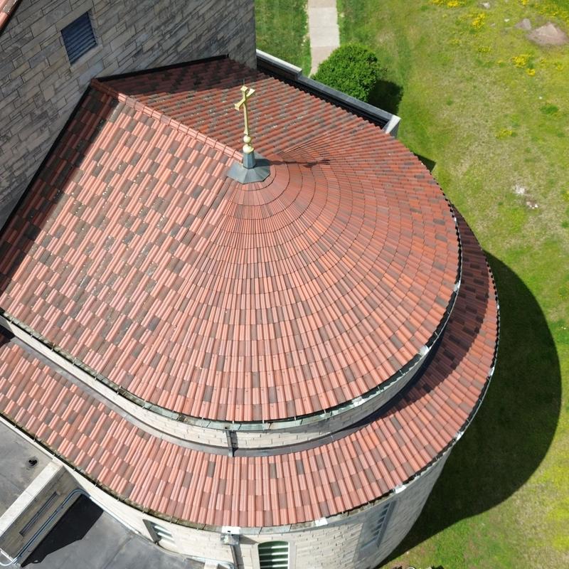 Old tile roof with circular dome and cross finial Old tile roof with circular dome and cross finial
