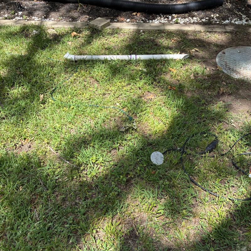 Outdoor sewer drain pipe with cleaning equipment on grass Outdoor sewer drain pipe with cleaning equipment on grass