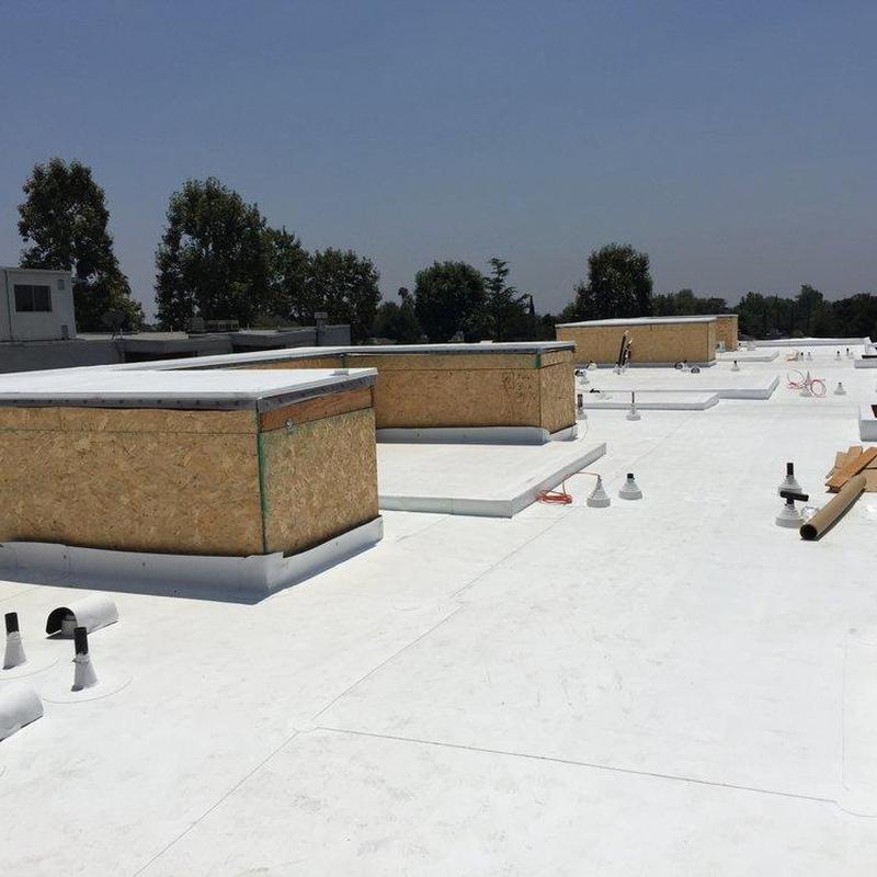 White commercial flat roof with ventilation pipes White commercial flat roof with ventilation pipes