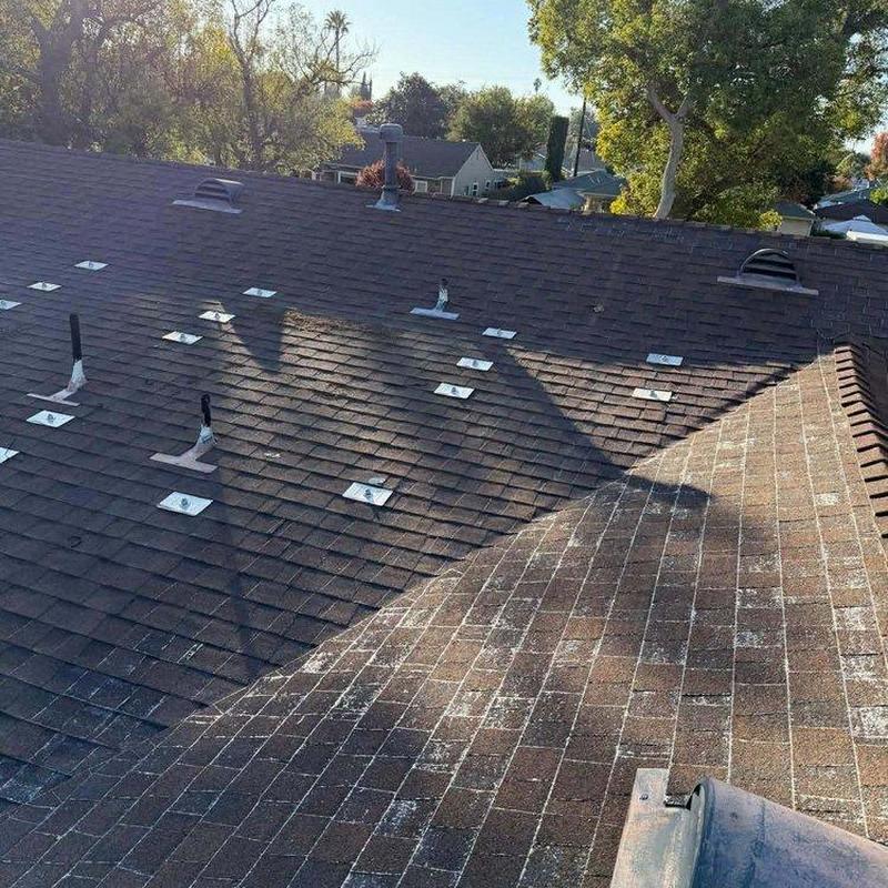 Shingle roofing with vent pipes and metal flashing Shingle roofing with vent pipes and metal flashing