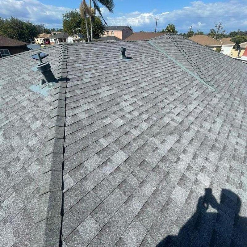 Shingle roof installation with ventilation pipes on house Shingle roof installation with ventilation pipes on house