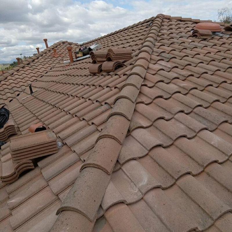 Tile roof with stacked replacement tiles on ridge line Tile roof with stacked replacement tiles on ridge line