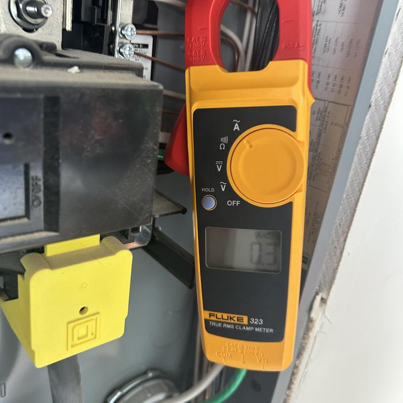 Treadmill circuit testing with clamp meter in electrical panel