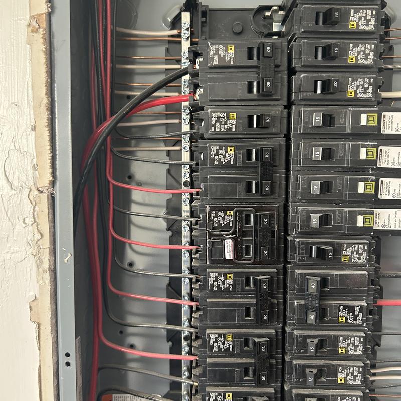 Electrical panel circuit breakers with red wiring