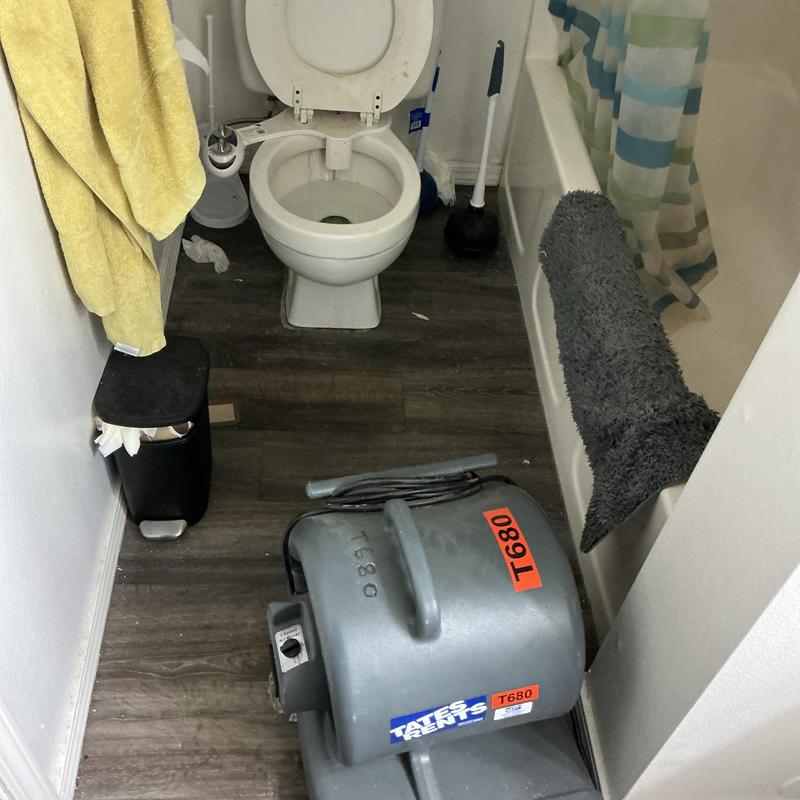 Toilet with plumbing cable machine in bathroom