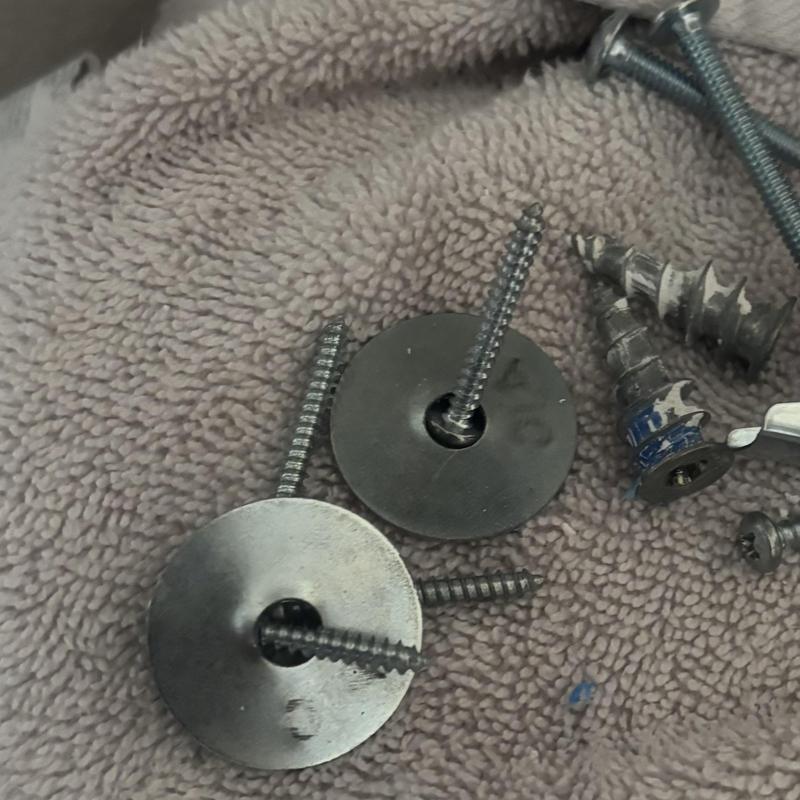 Water softener drywall anchors and screws on towel