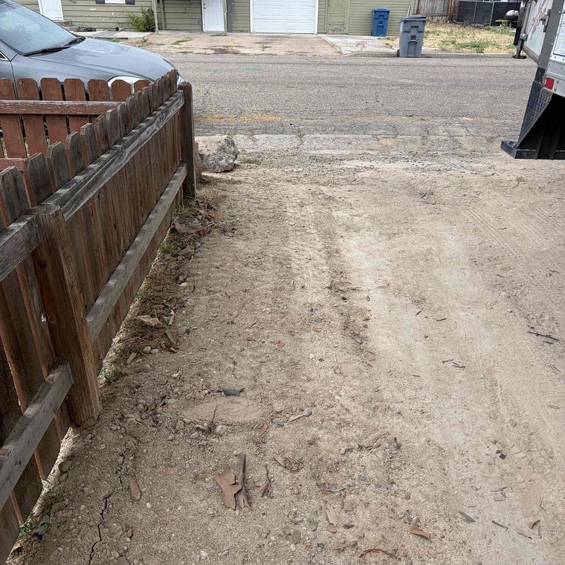 Sewer main replacement site with dirt excavation near fence