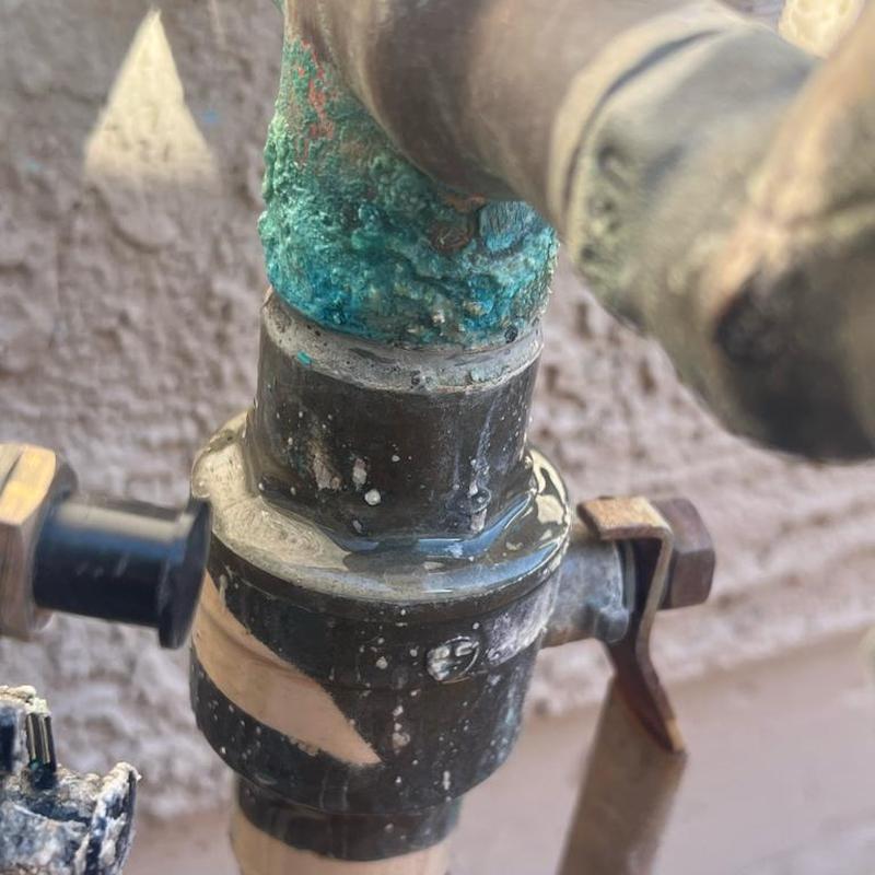 Water main leak at pipe joint with corrosion buildup Water main leak at pipe joint with corrosion buildup
