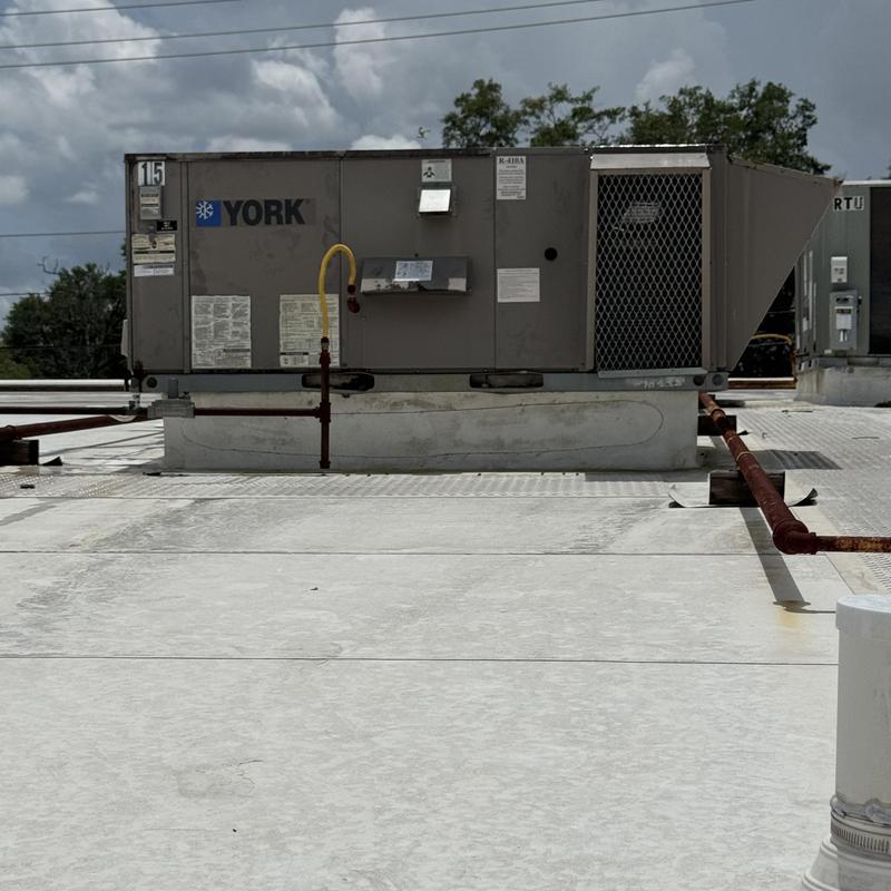 Rooftop unit with sealed weather stripping on roof