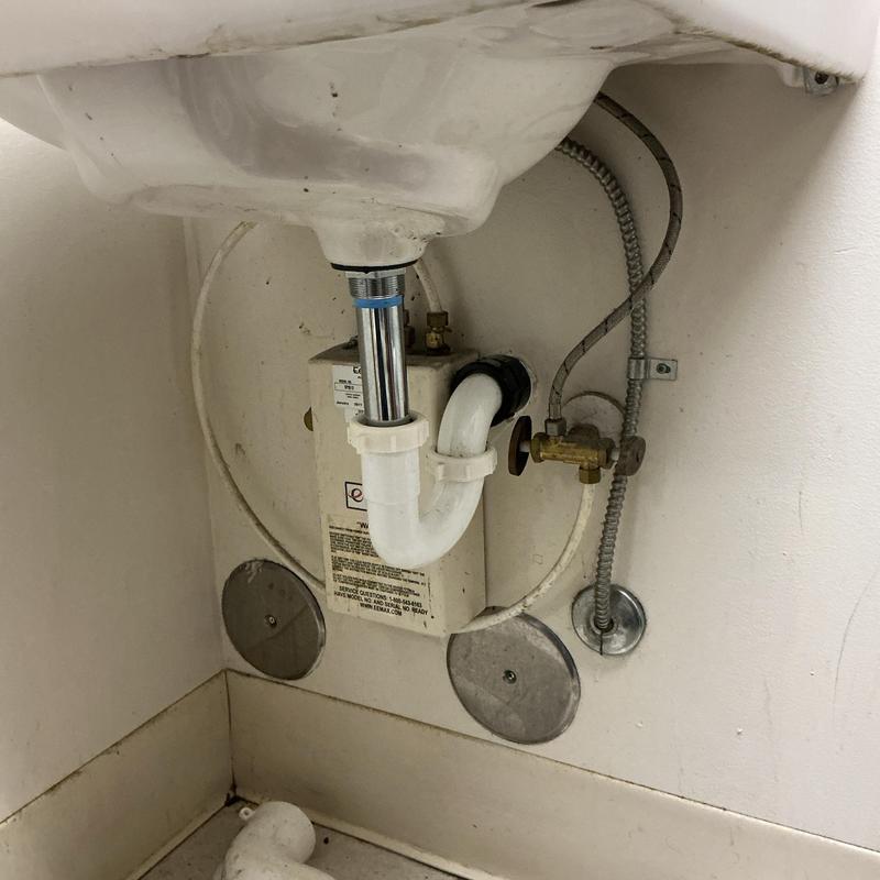 Sink drain pipe and water shutoff valve under sink