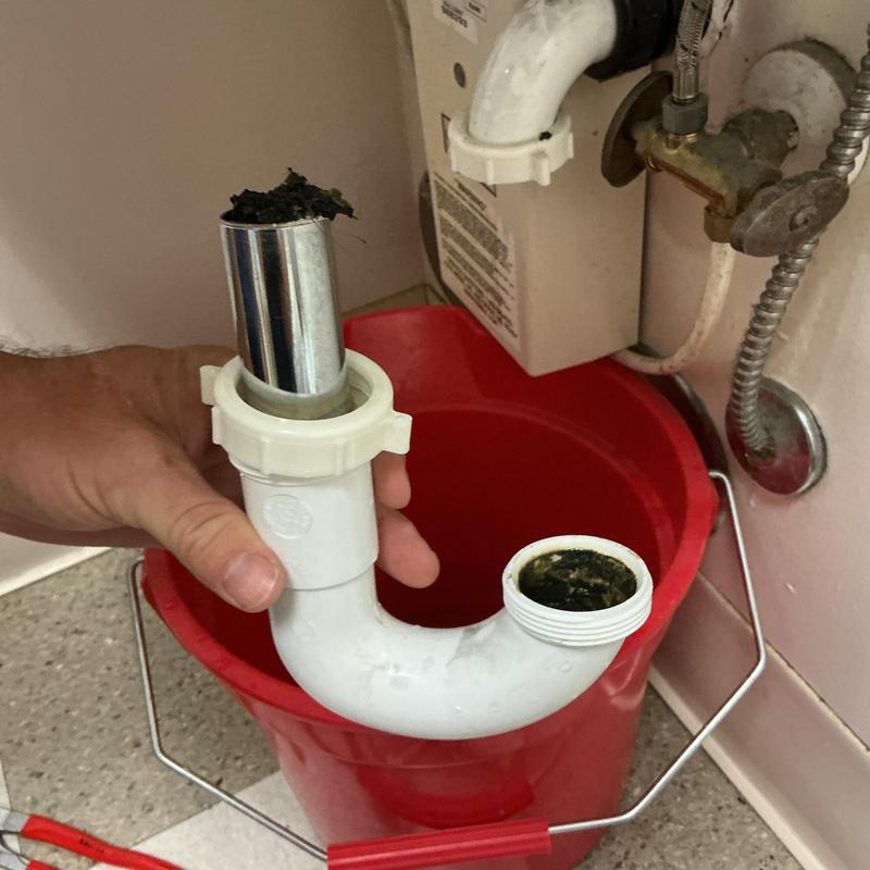 Sink drain pipe with clog and debris removal