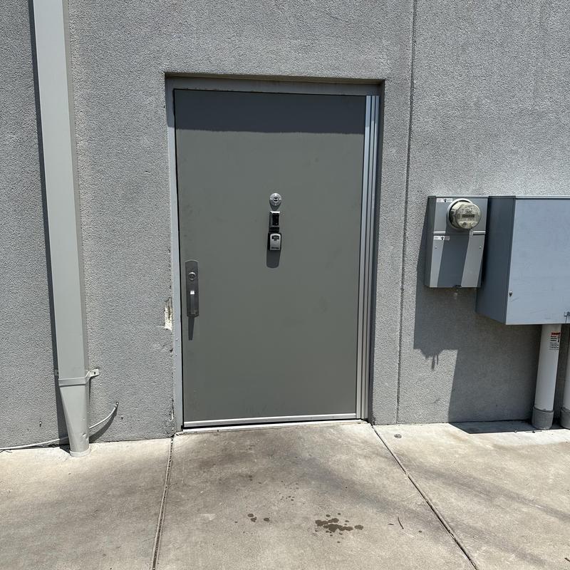 Metal security door with new Select hinge kit installed