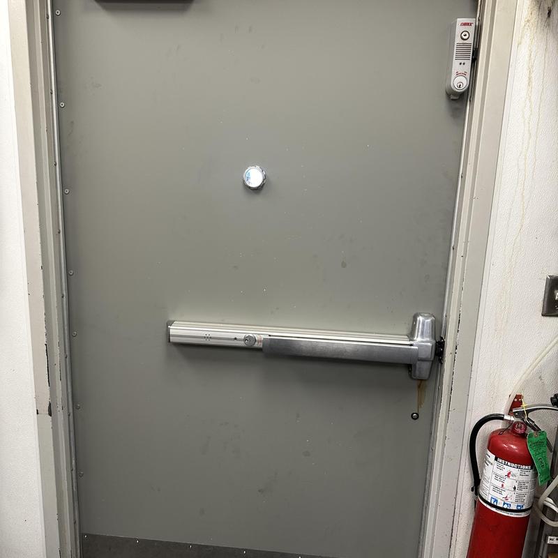 Fire exit door with panic bar and peephole installed