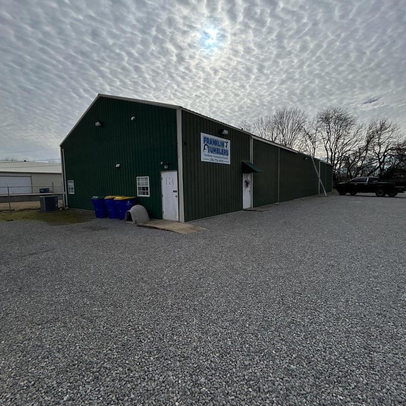 Metal building exterior with gravel parking lot