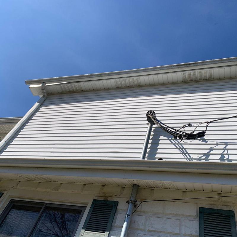 Vinyl siding with electrical wire conduit on house exterior