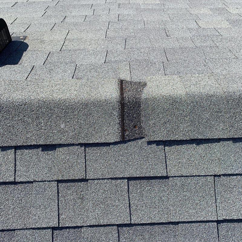 Roof ridge shingles with hail damage and wear