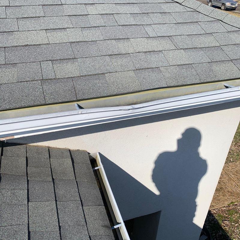 Roof shingles and metal drip edge with hail damage