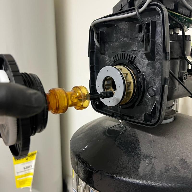 Water softener seal stack leak repair close-up Water softener seal stack leak repair close-up