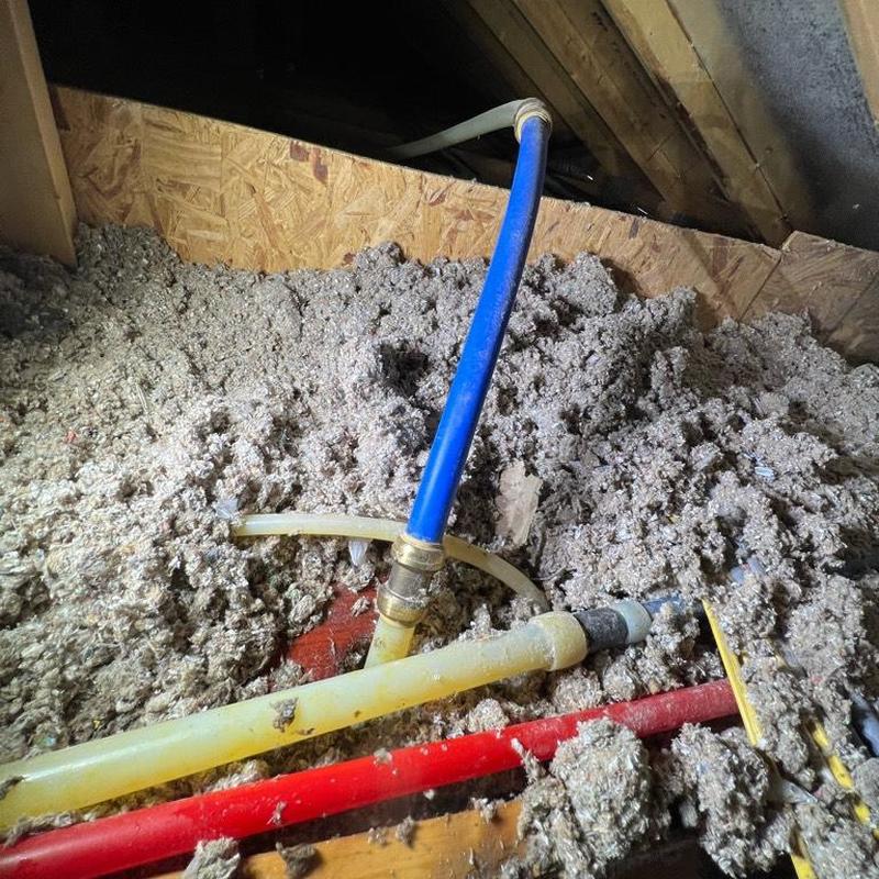 1-inch main feed PEX pipe with fittings in attic insulation 1-inch main feed PEX pipe with fittings in attic insulation