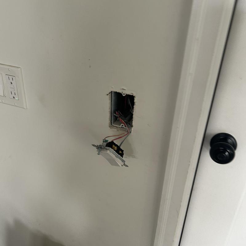 Electrical light switch box with exposed wires in wall