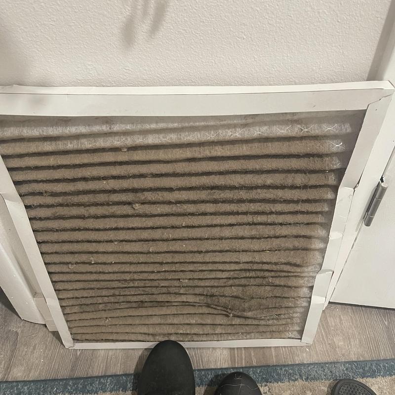 Air handler clogged air filter showing heavy dust buildup