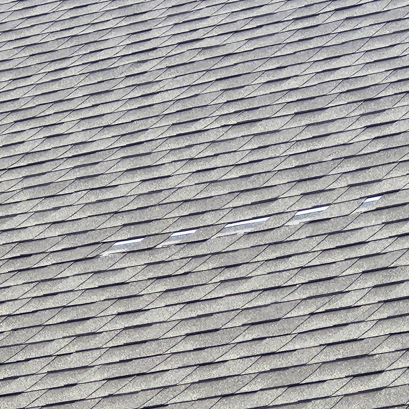 Asphalt roof shingles with wind damage gaps