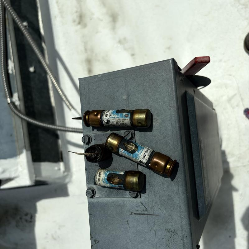 HVAC rooftop unit fuses showing burn damage