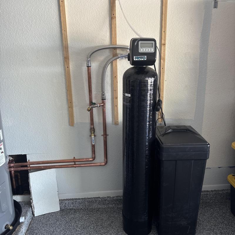 Water softener system with pressure regulator valve installed