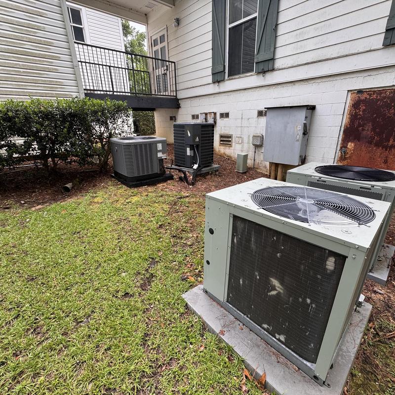 Heat pump outdoor units by commercial building exterior