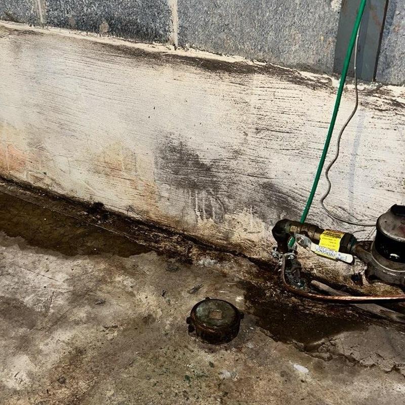 Basement water meter and leaking pipe with stains Basement water meter and leaking pipe with stains