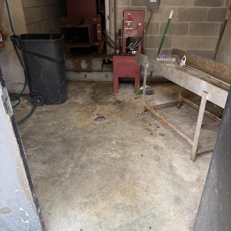 Floor drain in industrial utility room with equipment Floor drain in industrial utility room with equipment