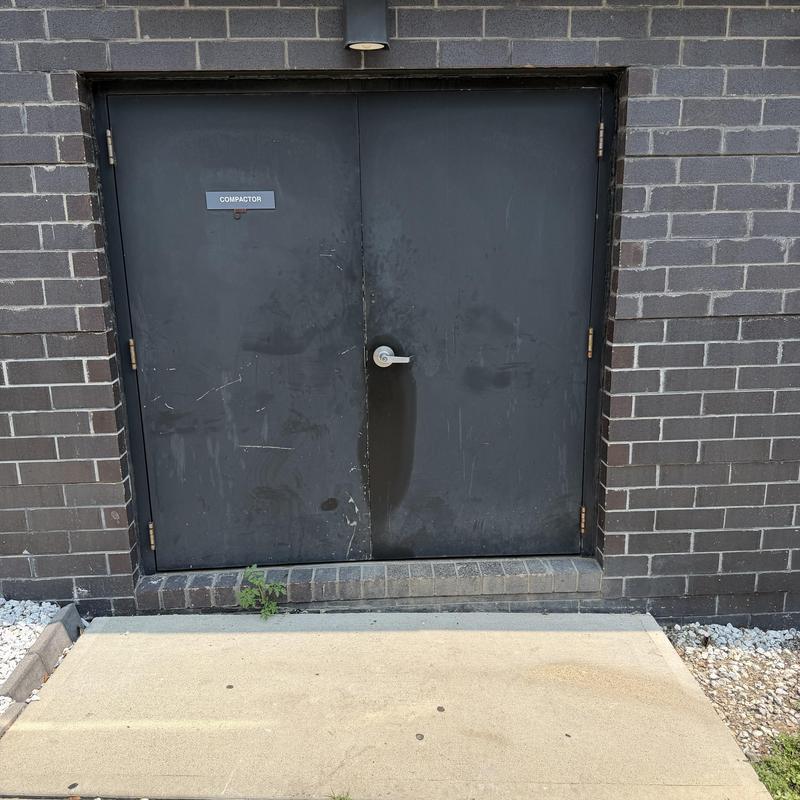 Compactor room exterior door on brick building Compactor room exterior door on brick building