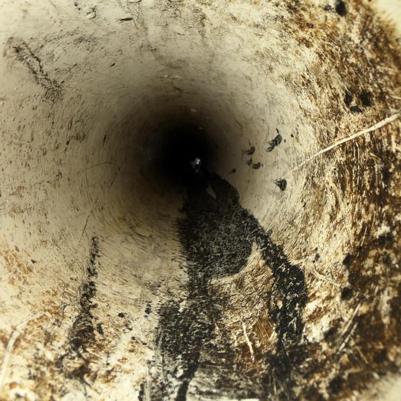 Main line floor drain pipe interior with buildup and debris Main line floor drain pipe interior with buildup and debris