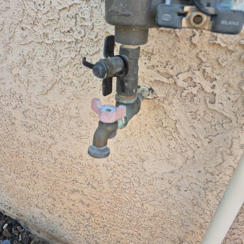 Outdoor hose bib with pressure vacuum breaker on wall