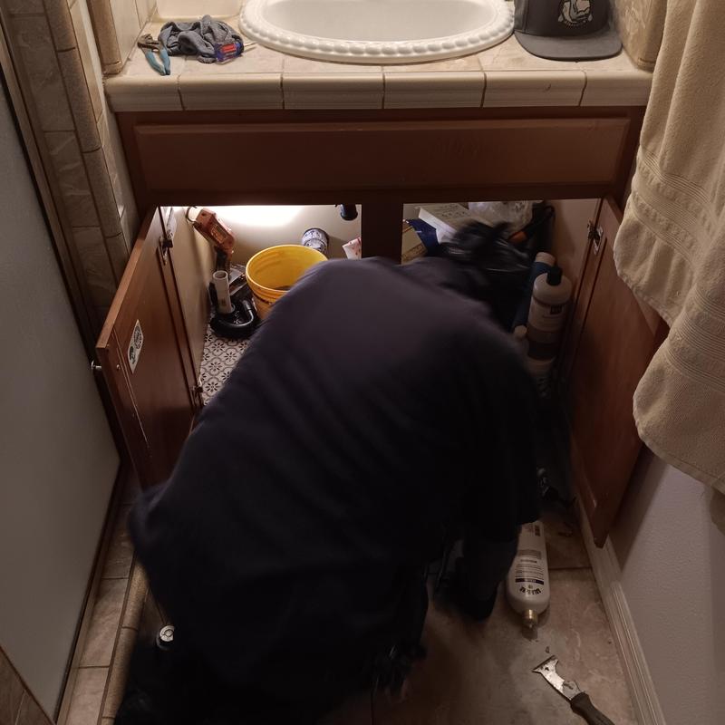 Bathroom sink plumbing cabinet with tool bucket