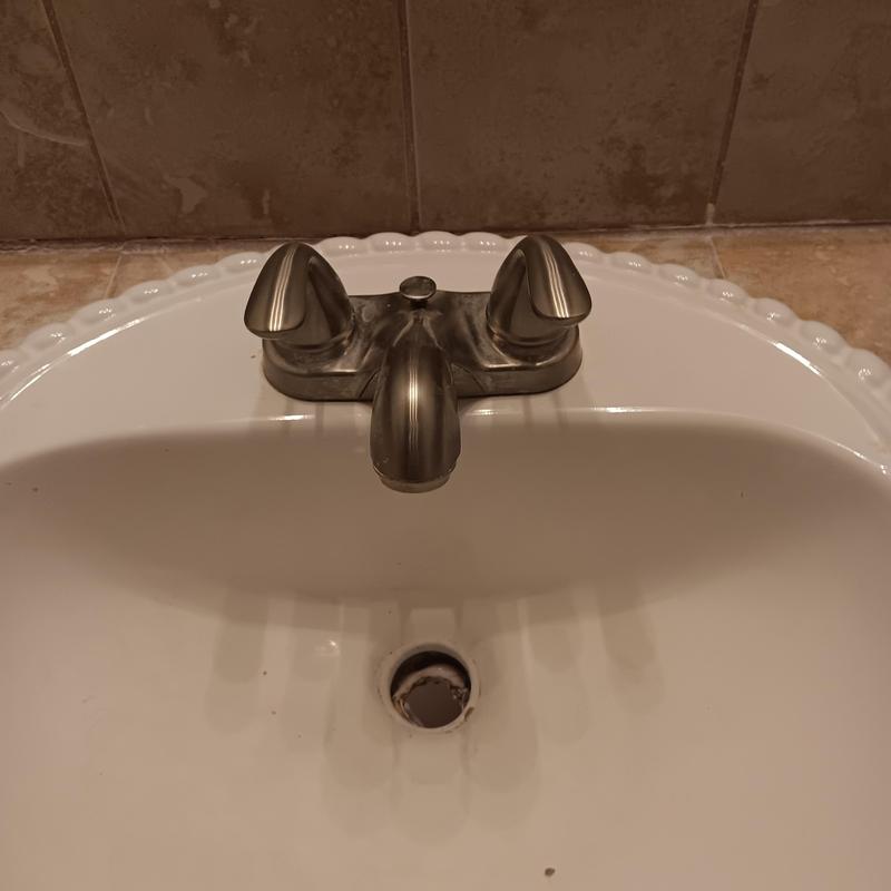 Bathroom sink faucet with dual handles and drain hole