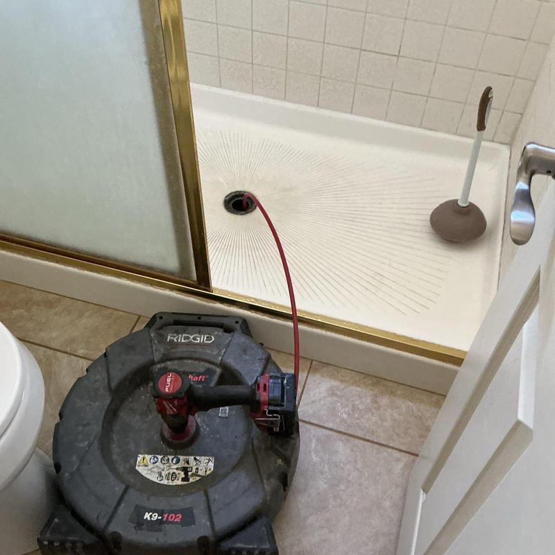 Main sewer line snake service in shower drain