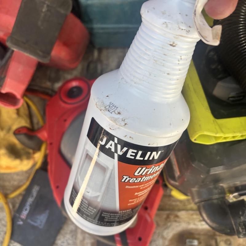 Urinal drain cleaning with Javelin treatment bottle