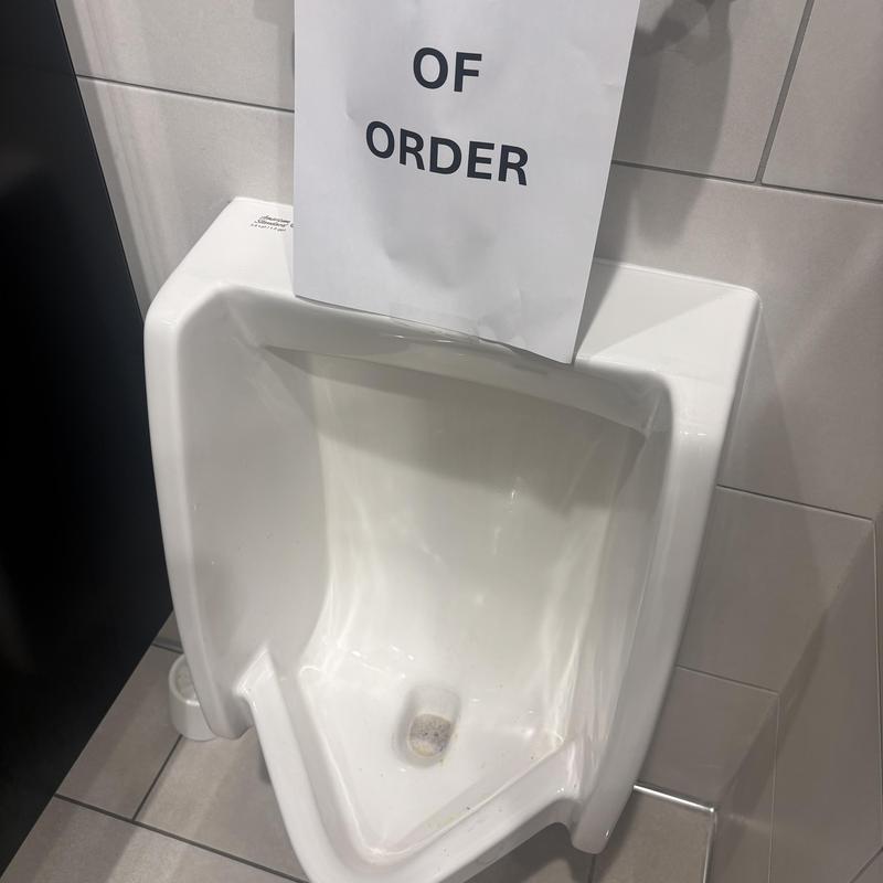 Urinal drain cleaning with calcium buildup treatment